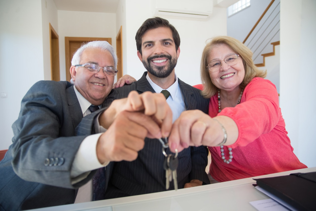 Image of three people holding a key for the probate real estate agent los angeles Blog Article