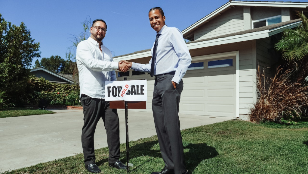 Image of man in a handshake with a realtor for the probate real estate agent los angeles Blog Article